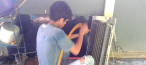 A man washing an air conditioner