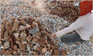 This lady uses hammer to make aggregate