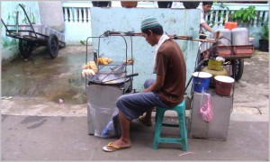 Street vendor cooking and selling fried stuff